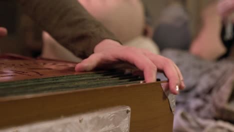 person playing a harmonium