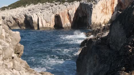 big wave splashes on rock in foreground from choppy sea