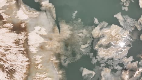 Glacial-meltwater-lake-with-floating-ice-and-snow,-Klausenpass,-Urner-Boden,-Switzerland