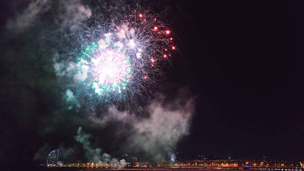 Fireworks Display Over Cityscape at Night