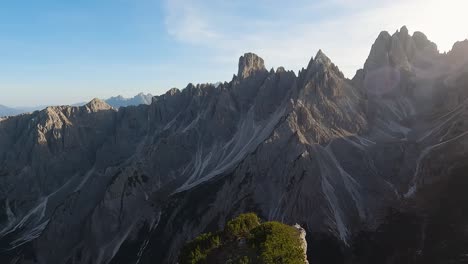 high noon sun casts light across rugged sharp peaks of the dolomites from scenic vista