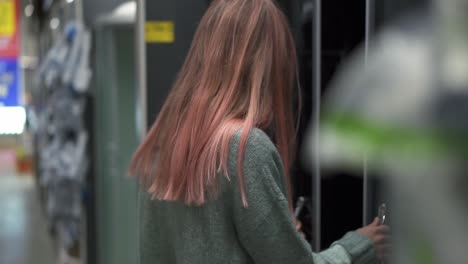 Long-Haired-Woman-In-Store-Chooses-A-Shower-Stall-For-The-Bathroom