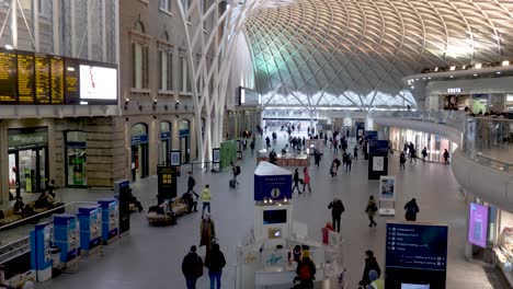 view of travellers walking across kings cross train station concourse below on 1st march 2022