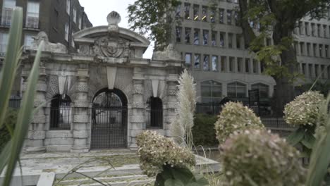 ancient gate with flowers in a city park