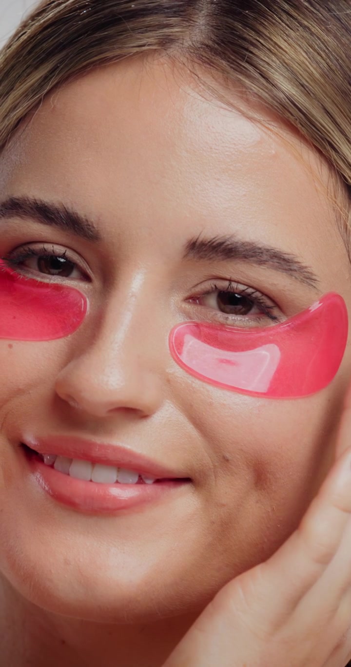 Young Woman Applying Pink Under Eye Patches for Skincare