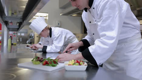 cook slicing fruit and putting them in a bowl