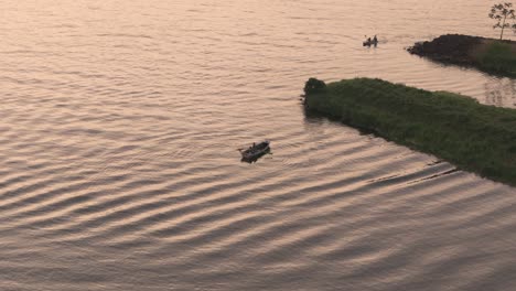 Aerial-Tracking-Shot-Of-People-In-Rowboat-And-Kayak-At-Sunset