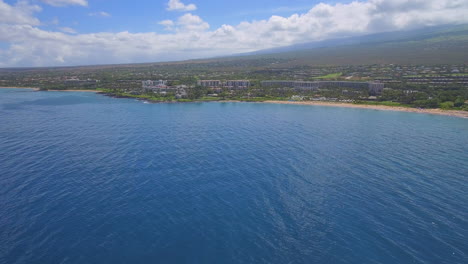 Flying-up-to-hotel-and-resort-on-beach-on-the-coast-of-the-Hawaiian-island-of-Maui---wide