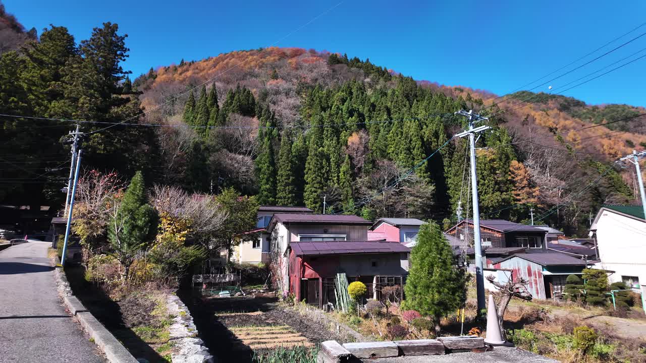 Traditional houses blending with the vibrant autumn colors of Narai juku, a charming post town on the Nakasendo Way in Japan