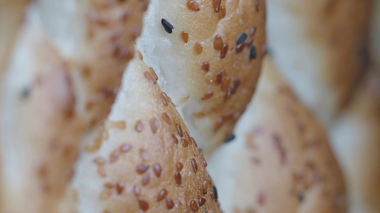Close-up view of braided bread with sesame seeds