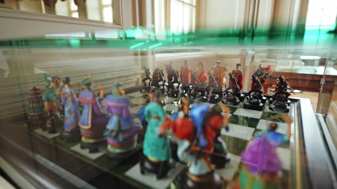 Close up of vintage chess board and ornate figures lit by natural light indoors