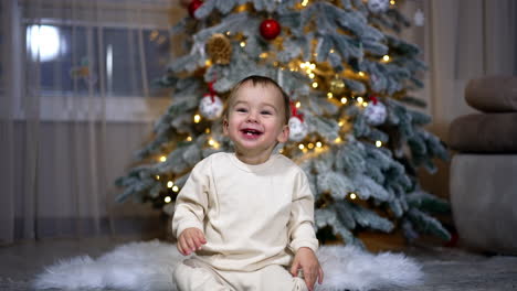 happy baby by christmas tree