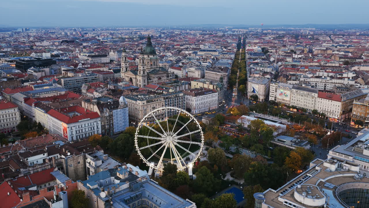 Budapest Eye and St. Stephen’s Basilica rise amid the city’s grand boulevards and historic rooftops at twilight