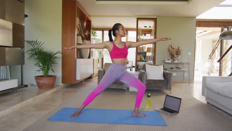 Mixed-race-woman-practising-yoga-at-home