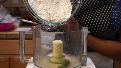 sifting flour into a food processor to mix dough - chana masala series