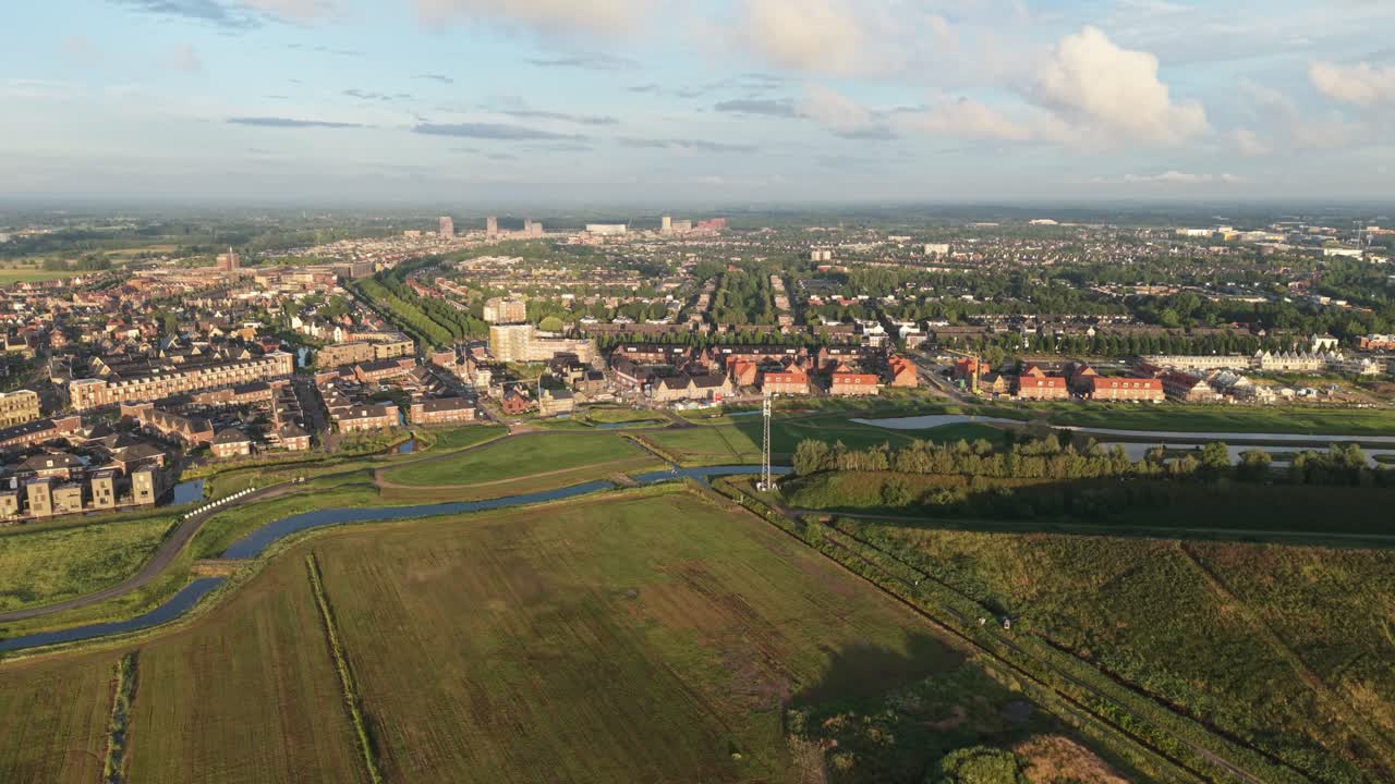 View above Amersfoort Vathorst residential area at sunset, modern Dutch suburban landscape. Aerial panning shot