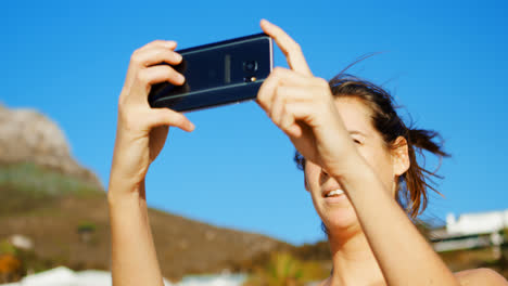 Female-volleyball-player-clicking-photos-with-mobile-phone-4k