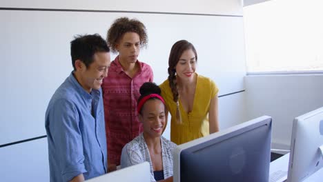 Multi-ethnic-business-people-discussing-over-computer-in-modern-office-4k