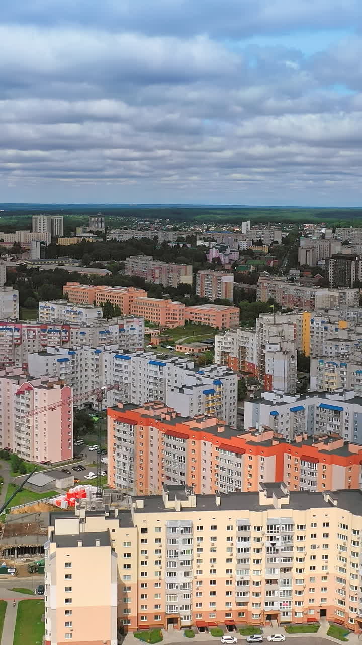 Modern city complex. High-raised buildings in the center of the city. New residential apartments. Aerial view Vertical video