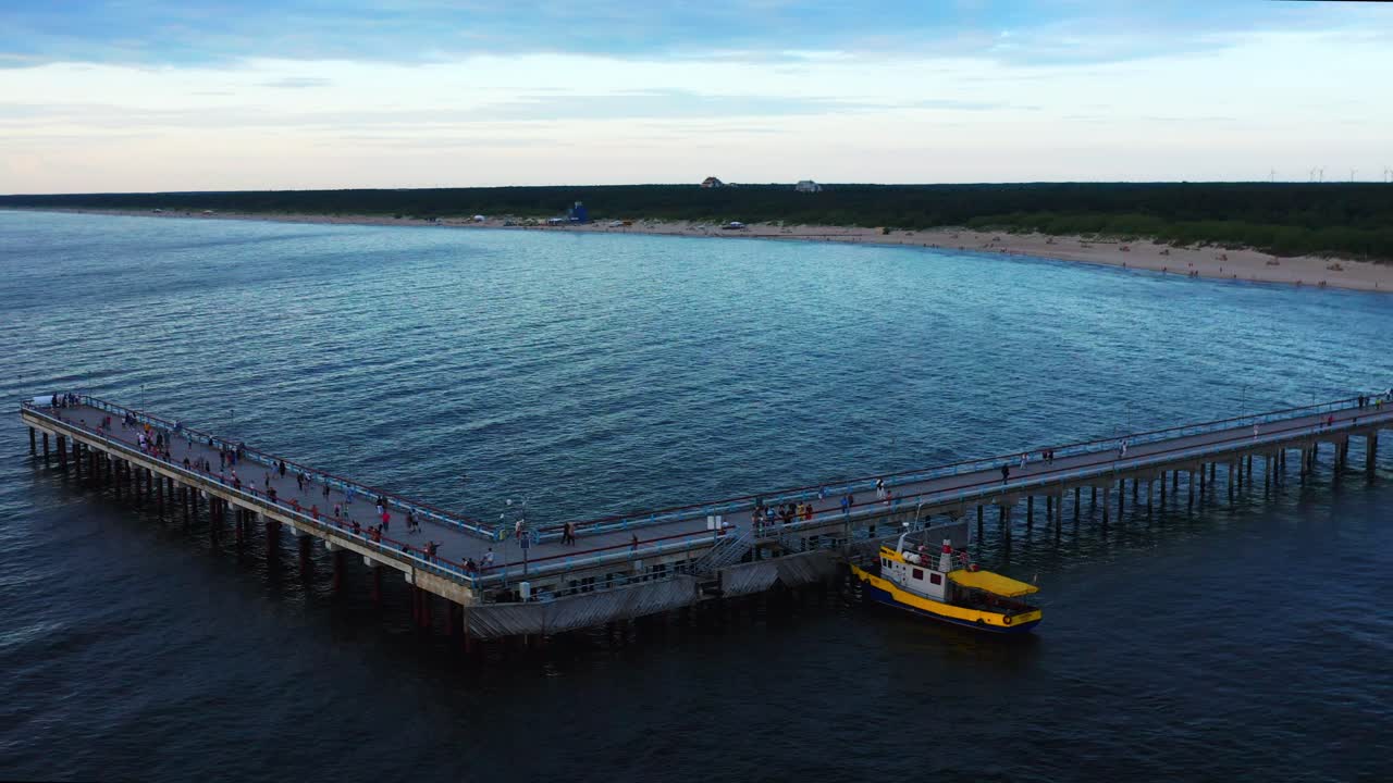 vista aérea de peatones caminando en el puente del muelle de palanga - famoso punto de referencia en lituania - disparo de drones