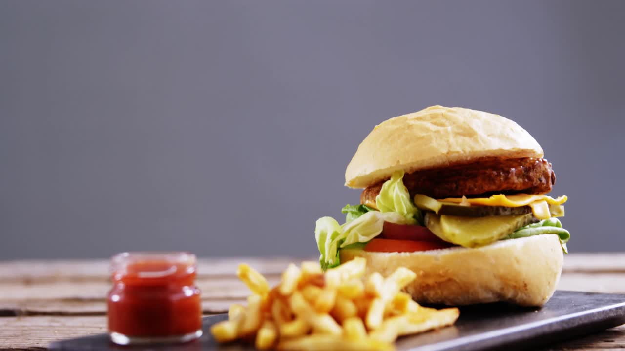 Hamburger and french fries with ketchup on slate board Premium Stock ...