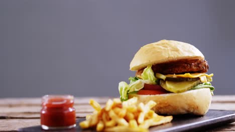 Hamburger-and-french-fries-with-ketchup-on-slate-board