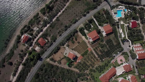 Flying-over-the-cottages-on-seafront-of-Trikorfo-Beach-Greece