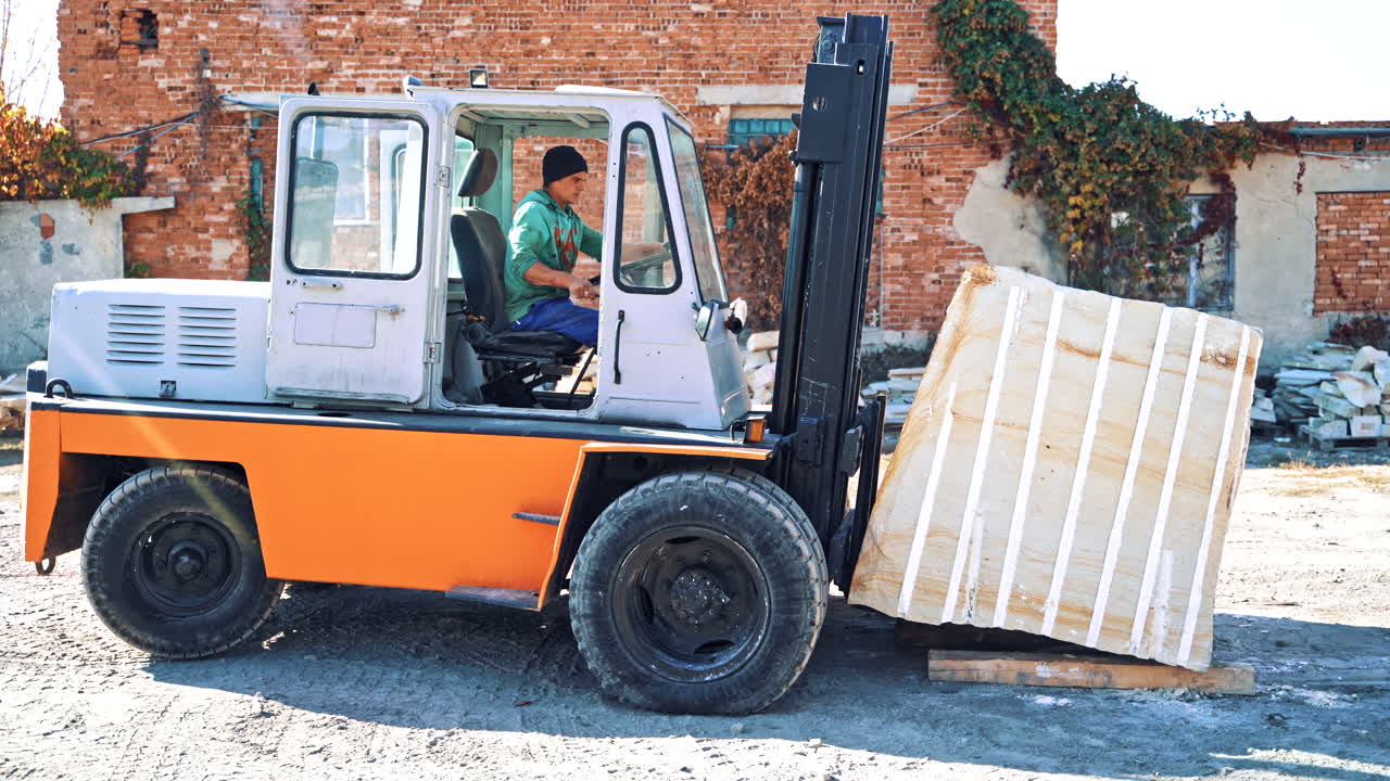 Forklift driving at quarry. Forklift driver loading the marble at quarry