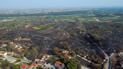 Aerial-establishing-of-a-burnt-village-destroyed-by-the-wildfires-in-northern-Greece,-August-2023