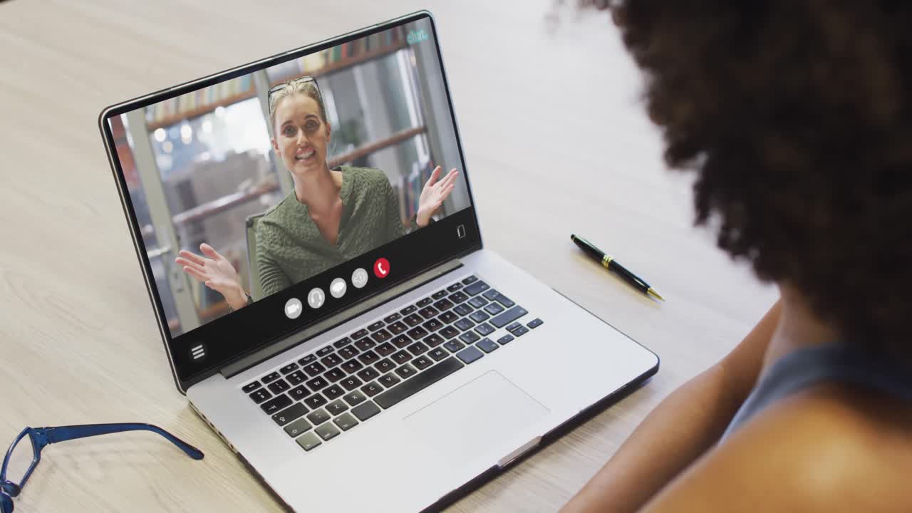 Animation of african american woman having video call on laptop