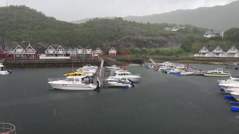 static shot of heavy rain pouring down in a norwegian harbor during summer in nordland