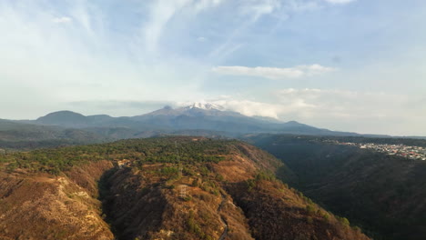 aerial tracking shot of a village and highland nature, in sunny puebla, mexico