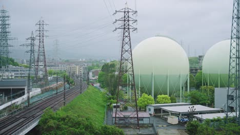 gloomy industrial area, power lines and gas tanks in osaka japan