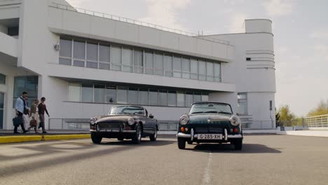 vintage cars and friends at a modern airport
