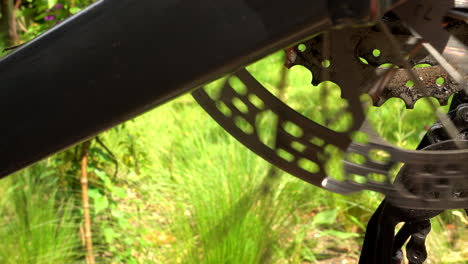 bicycle disc brake on rear wheel spinning, closeup