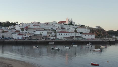 ferragudo looking splendid as birds fly by overhead, portugal