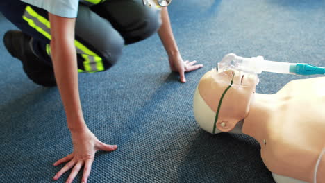 woman exercising her first aid on a model