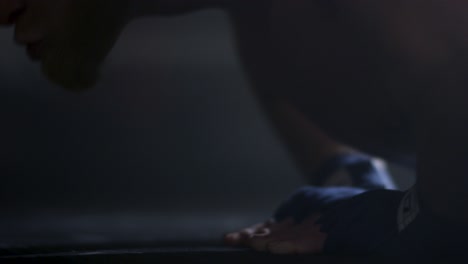 man doing push-ups with boxing wraps