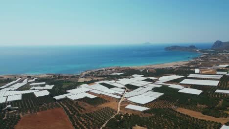 above view of coastal greenhouses along falassarna beach on the west coast of crete, greece. aerial drone shot