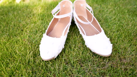 a-pair-of-white-shoes-sitting-on-top-of-a-green-field