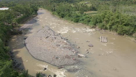 Aerial-view-of-rocky-river-with-small-island-in-the-middle-of-water-stream