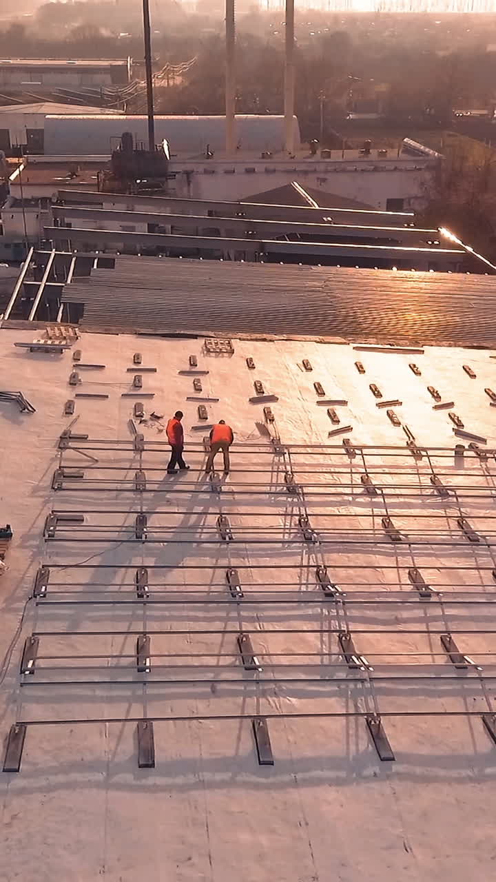 Solar technician installing panels. Installing alternative energy photovoltaic solar panels on roof