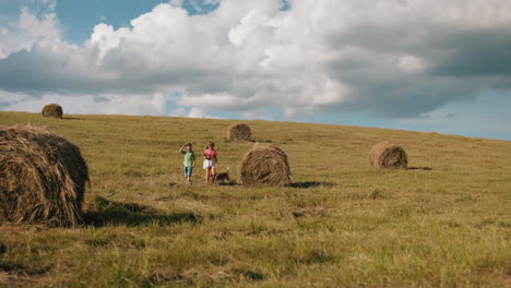 siblings enjoy a fun moment running around hay bales in a vast farmland with their dog, the children laugh and play freely in the open field under a bright sky