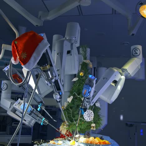 operating table with christmas ornaments and impressive robotic arms over it. surgery room with da vinci system peeling tangerines and decorating fir-tree. special surgery equipment at the background