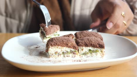 person eating pistachio baklava