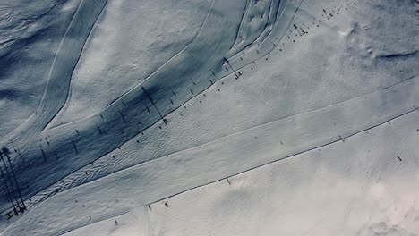 Above-white-snow-ski-piste-during-winter-season-with-chairlift