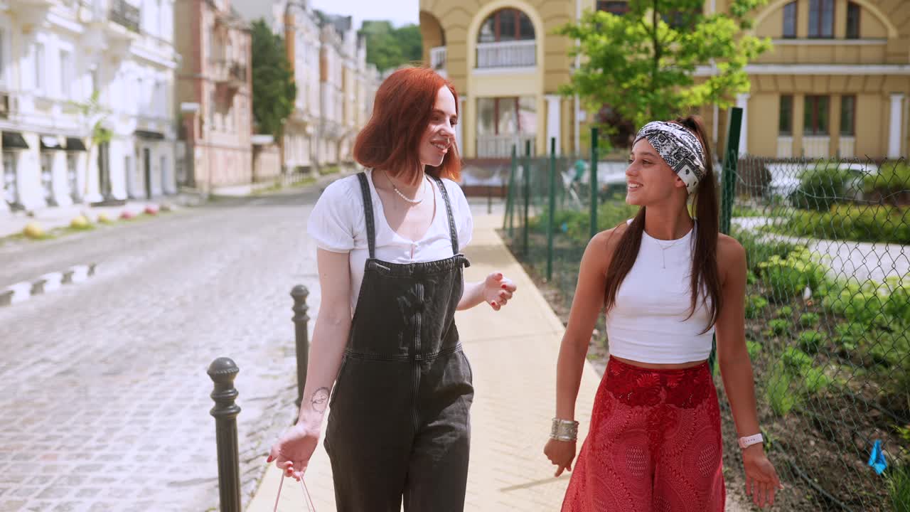 Two young women walking and talking in the city