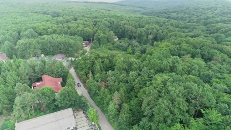 drone view of a rural community in the mountains covered with trees