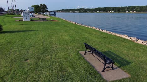 drone flight over an empty park bench looking over the mighty mississippi river in iowa