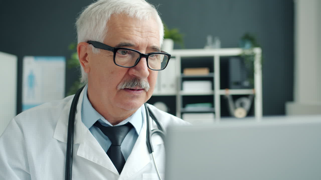 Doctor examining patient on laptop